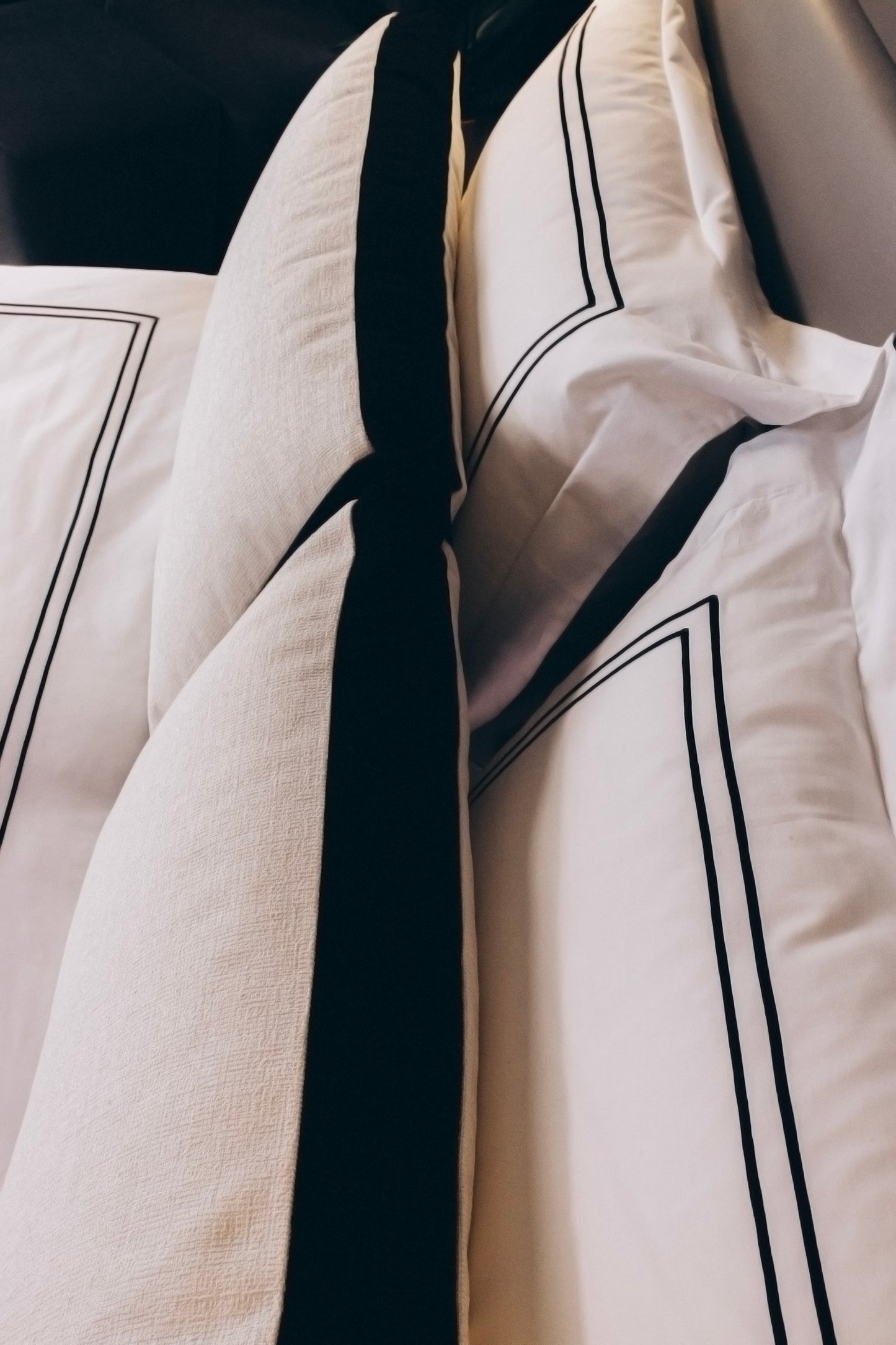 Two El Roy decorative cushions. Bed on top.